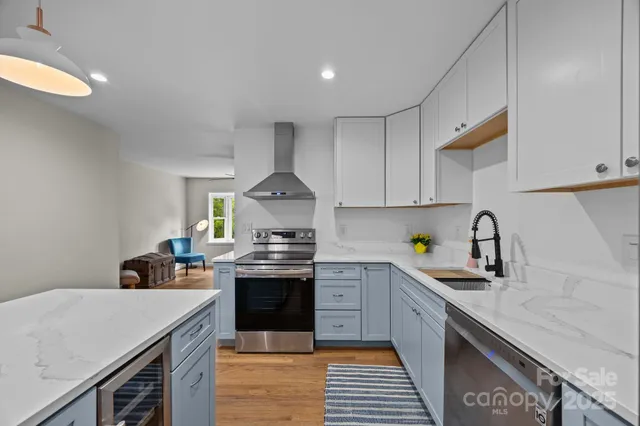 a kitchen with stainless steel appliances a sink stove and cabinets