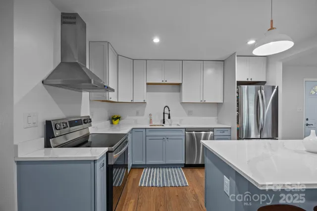 a kitchen with a sink a stove and refrigerator