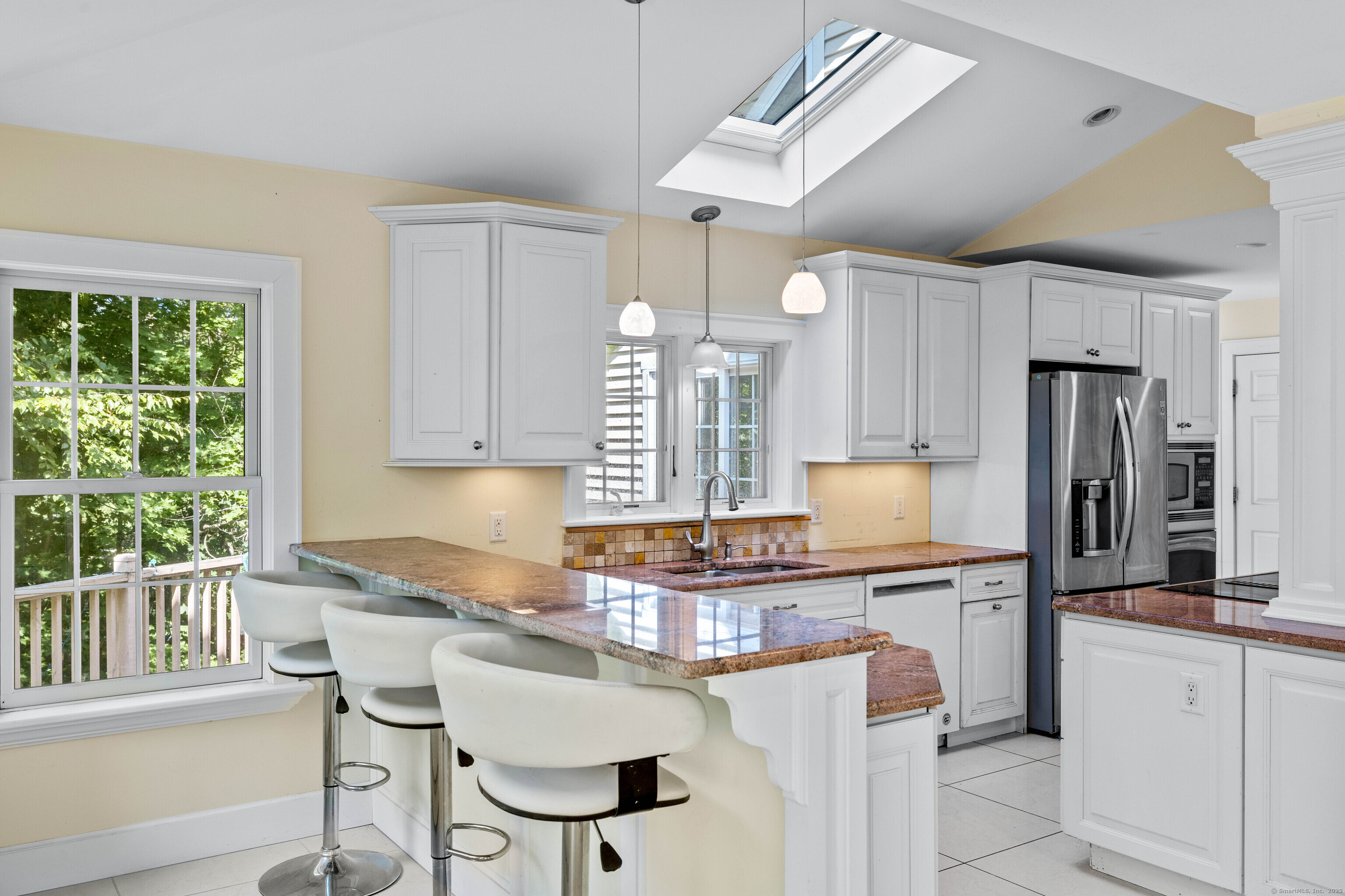 332 Lantern Hill Road Stonington, CT 06355 - Photo 13 of 38 a kitchen with refrigerator a sink and chairs