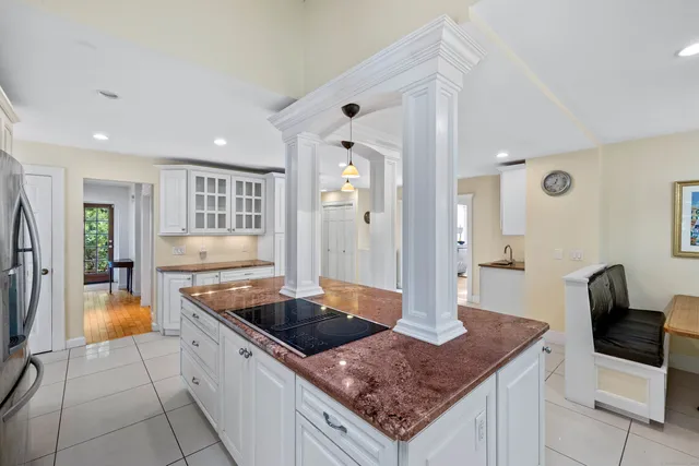 a kitchen with granite countertop a sink and a stove