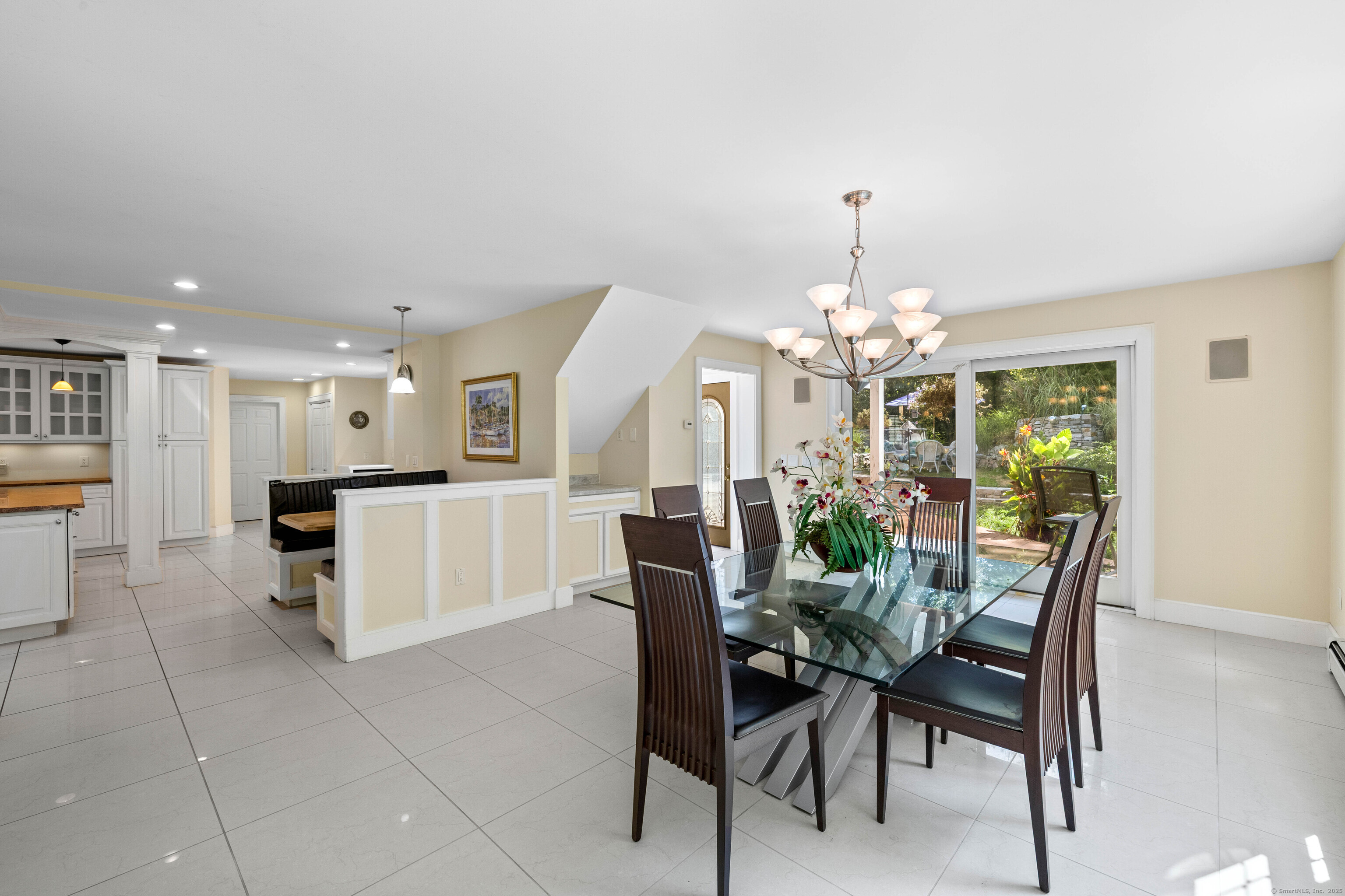 332 Lantern Hill Road Stonington, CT 06355 - Photo 17 of 38 a view of a dining room with furniture and a chandelier