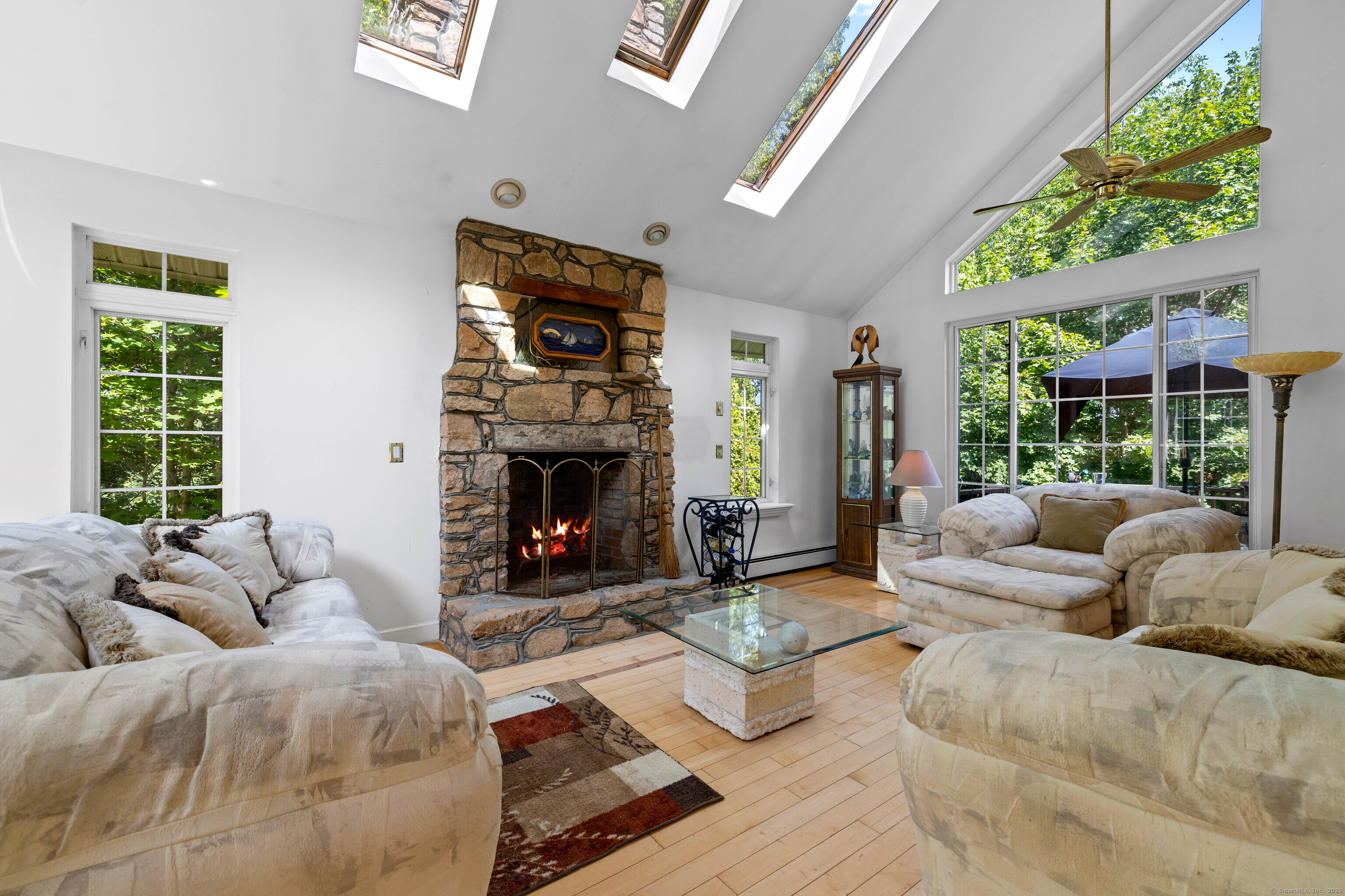 332 Lantern Hill Road Stonington, CT 06355 - Photo 19 of 38 a living room with furniture large window and a fireplace