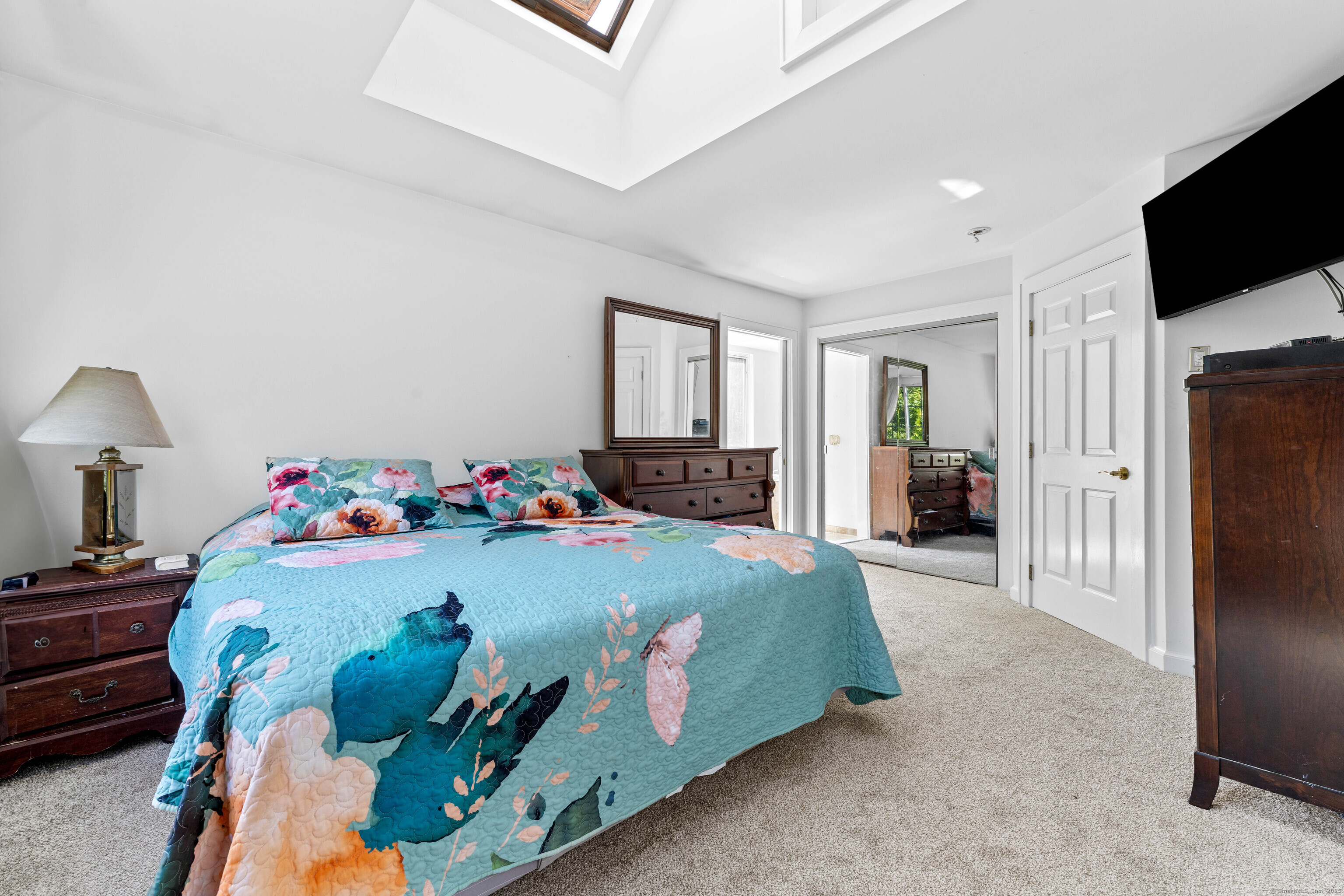 332 Lantern Hill Road Stonington, CT 06355 - Photo 27 of 38 a bedroom with bed and a flat tv screen on dresser