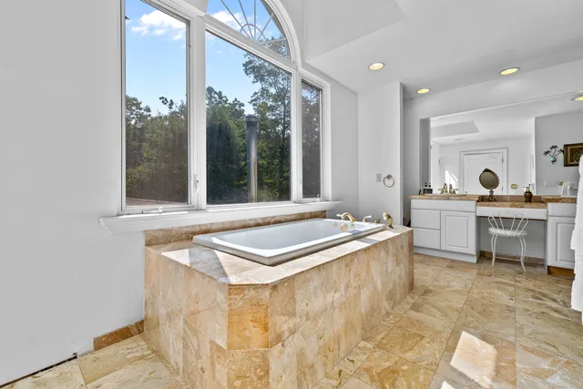 a room with table chairs and large window