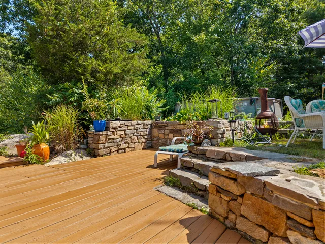 a view of a patio with table and chairs and potted plants