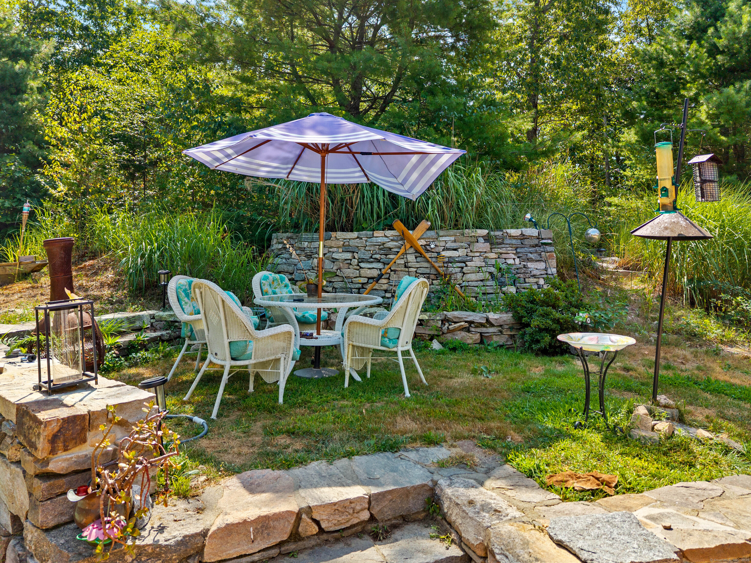 332 Lantern Hill Road Stonington, CT 06355 - Photo 31 of 38 a view of backyard with plants and outdoor seating
