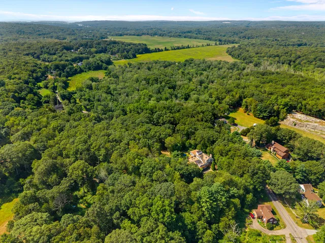 an aerial view of a house with a yard