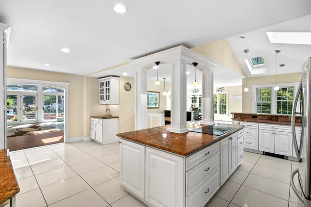 a large kitchen with kitchen island granite countertop a large counter top and sink
