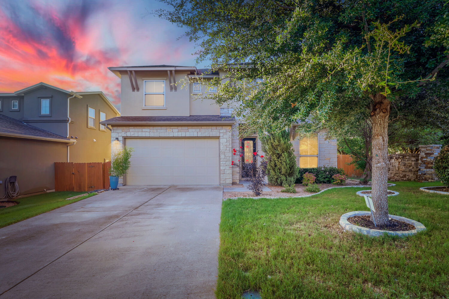 5821 Buchanan Draw Road Austin, TX 78738 - Photo 1 of 29 A well-kept front yard welcomes with lush grass and mature trees to this charming two-story home.