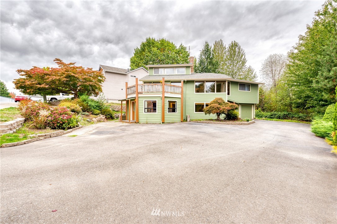 12216 Southeast 258 Place Kent, WA 98030 - Photo 2 of 40 a front view of a house with a garden and pathway