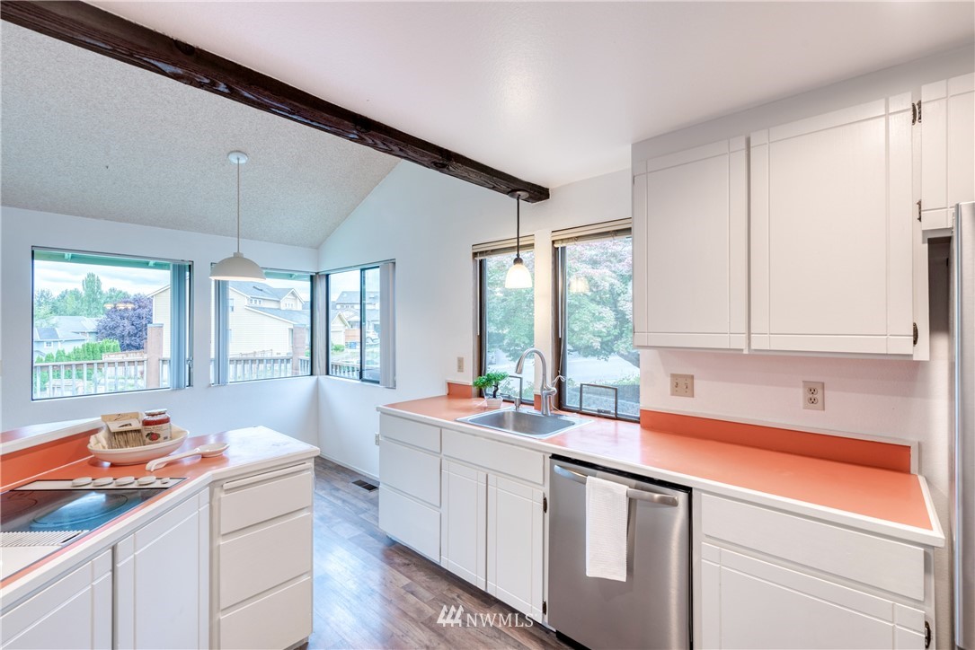 12216 Southeast 258 Place Kent, WA 98030 - Photo 18 of 40 a kitchen that has a sink and cabinets