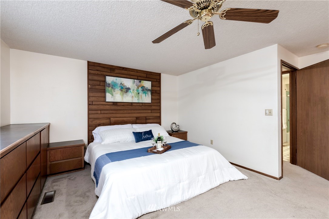 12216 Southeast 258 Place Kent, WA 98030 - Photo 25 of 40 a bedroom with a bed and a ceiling fan