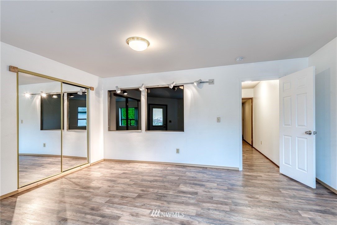 12216 Southeast 258 Place Kent, WA 98030 - Photo 33 of 40 a view of an empty room with wooden floor and windows