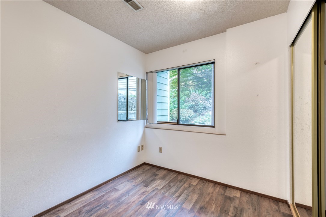 12216 Southeast 258 Place Kent, WA 98030 - Photo 34 of 40 an empty room with wooden floor and windows