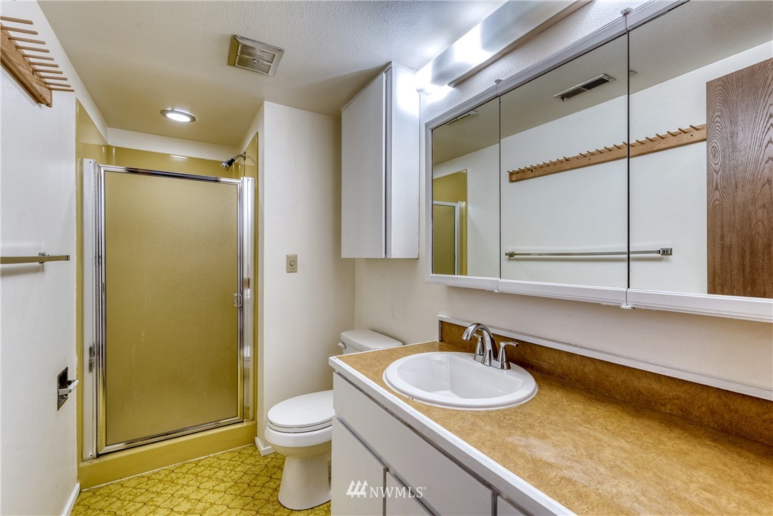 12216 Southeast 258 Place Kent, WA 98030 - Photo 35 of 40 a bathroom with a granite countertop sink toilet and shower