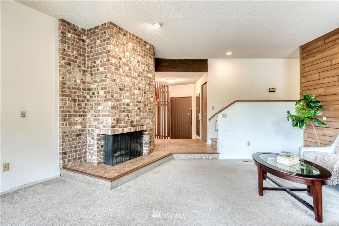 12216 Southeast 258 Place Kent, WA 98030 - Photo 7 of 40 a living room with furniture and a fireplace