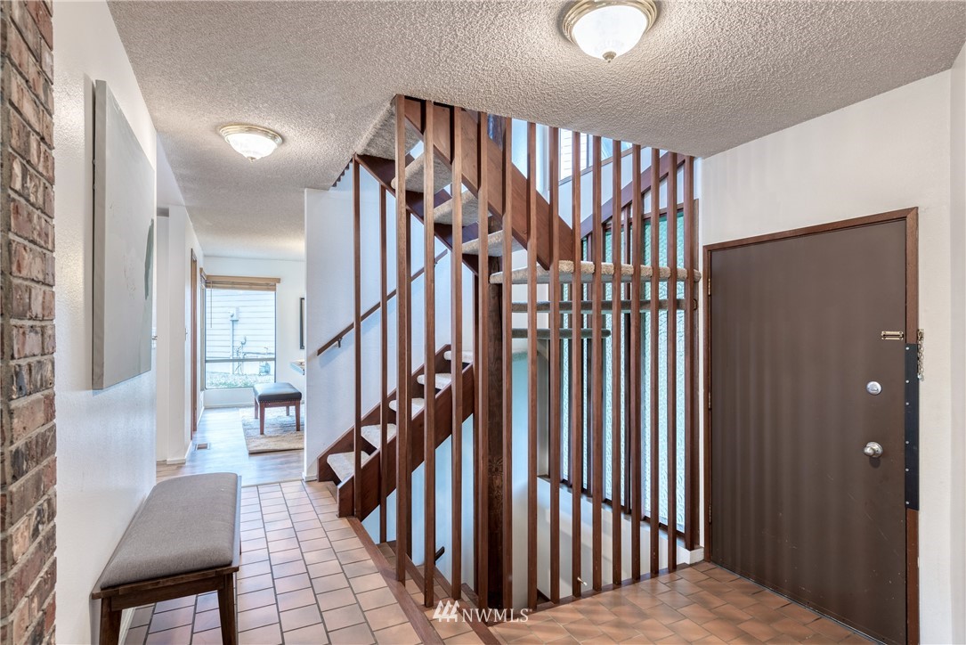12216 Southeast 258 Place Kent, WA 98030 - Photo 8 of 40 a view of staircase with railing and a chandelier