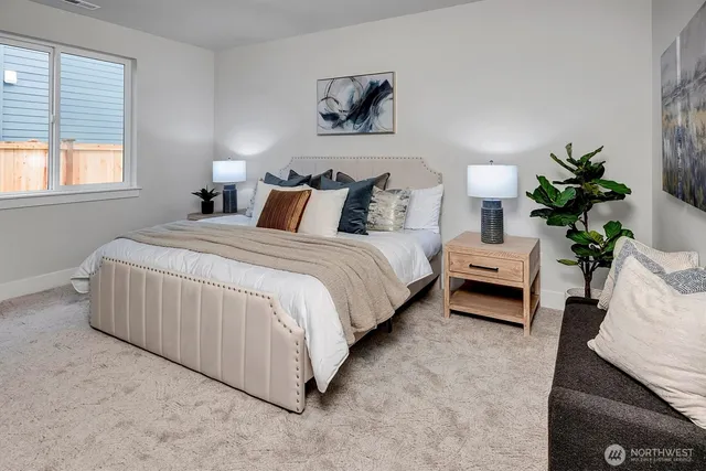 a spacious bedroom with a bed and a potted plant