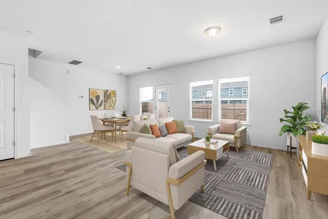 a living room with furniture and kitchen view