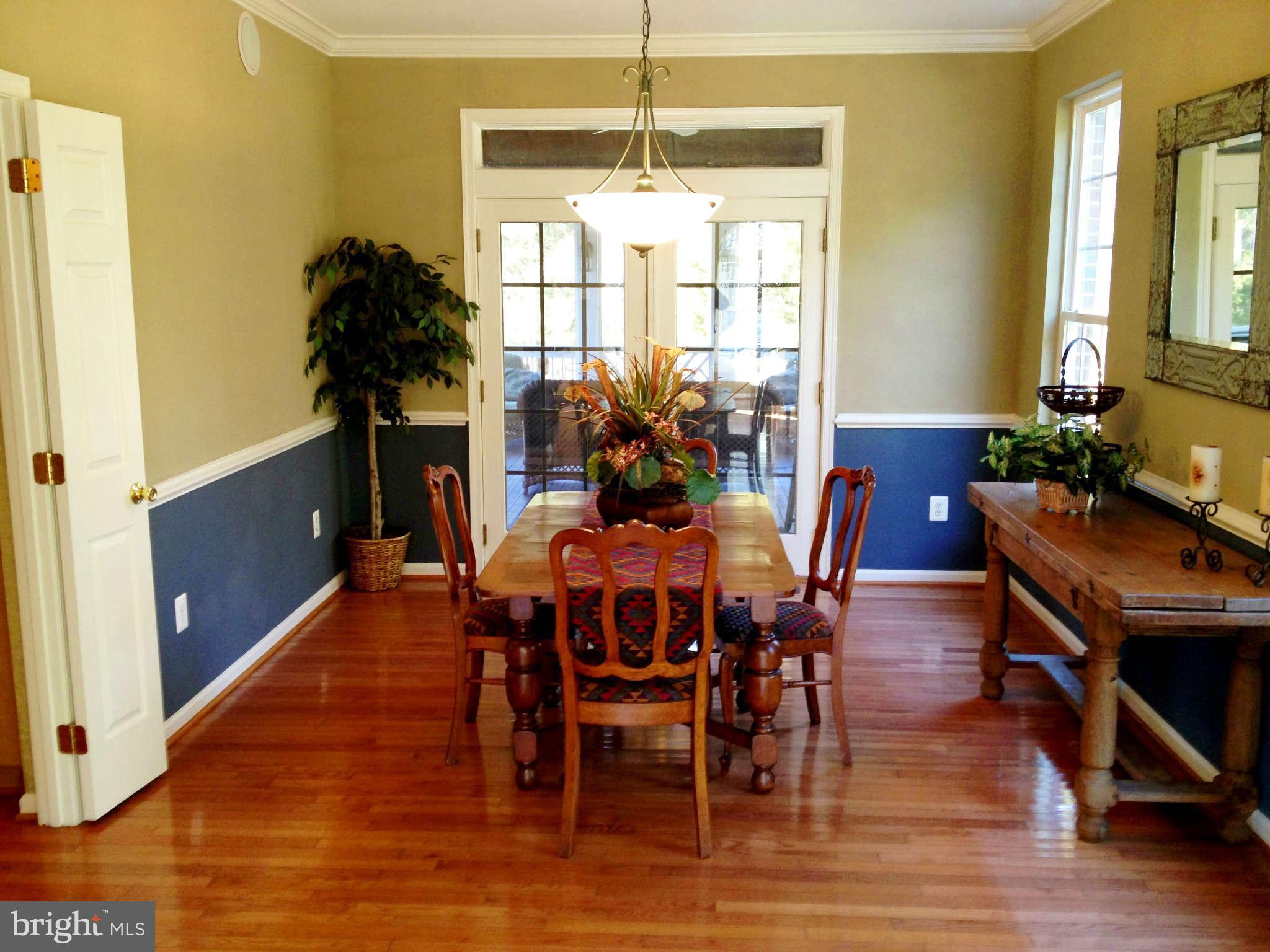 24904 Frederick Road Clarksburg, MD 20871 - Photo 11 of 30 a view of a dining room with furniture window and wooden floor