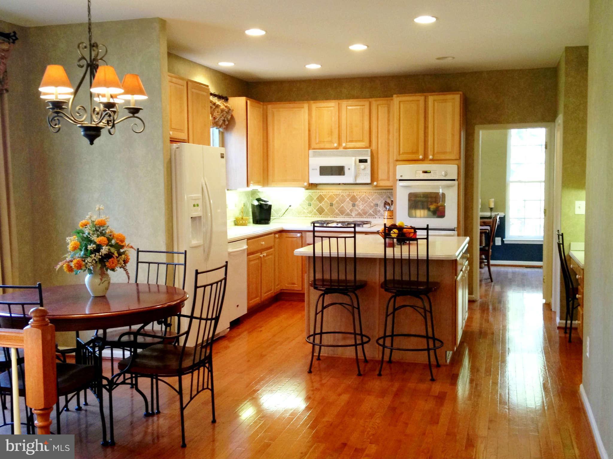 24904 Frederick Road Clarksburg, MD 20871 - Photo 12 of 30 a dining room with furniture and wooden floor