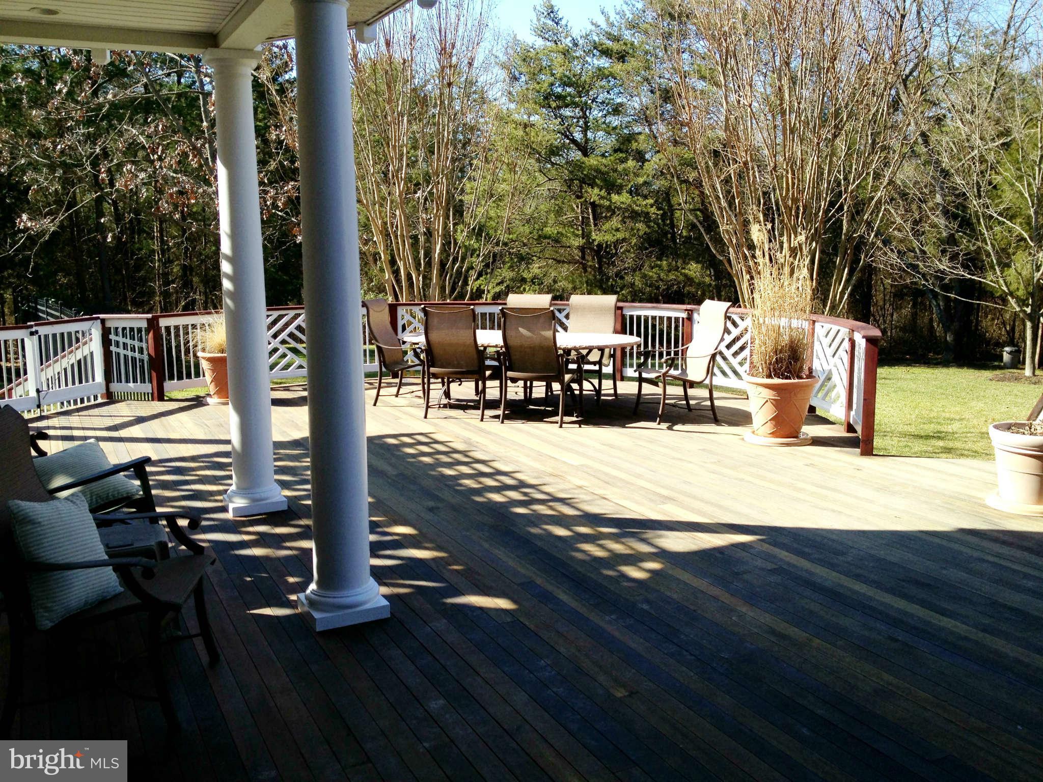 24904 Frederick Road Clarksburg, MD 20871 - Photo 4 of 30 a view of a patio with a table chairs and wooden fence