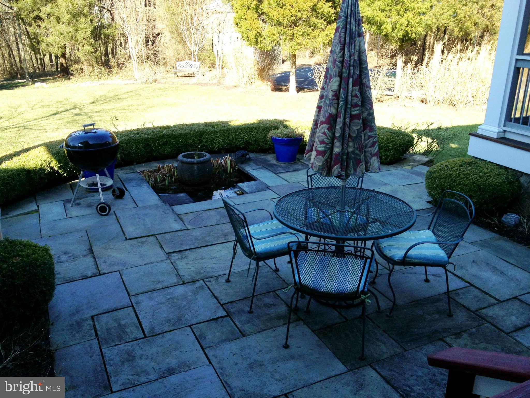 24904 Frederick Road Clarksburg, MD 20871 - Photo 7 of 30 a view of a backyard with furniture and a table