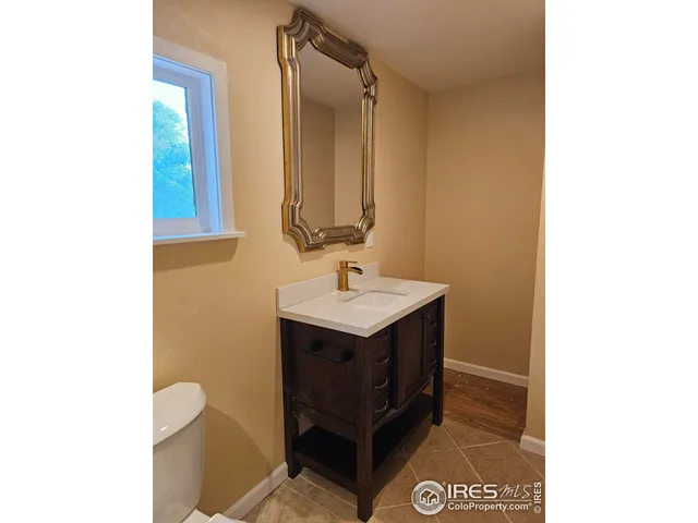 a bathroom with a sink toilet and mirror