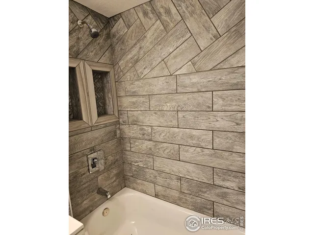 a bathroom with a bathtub and shower