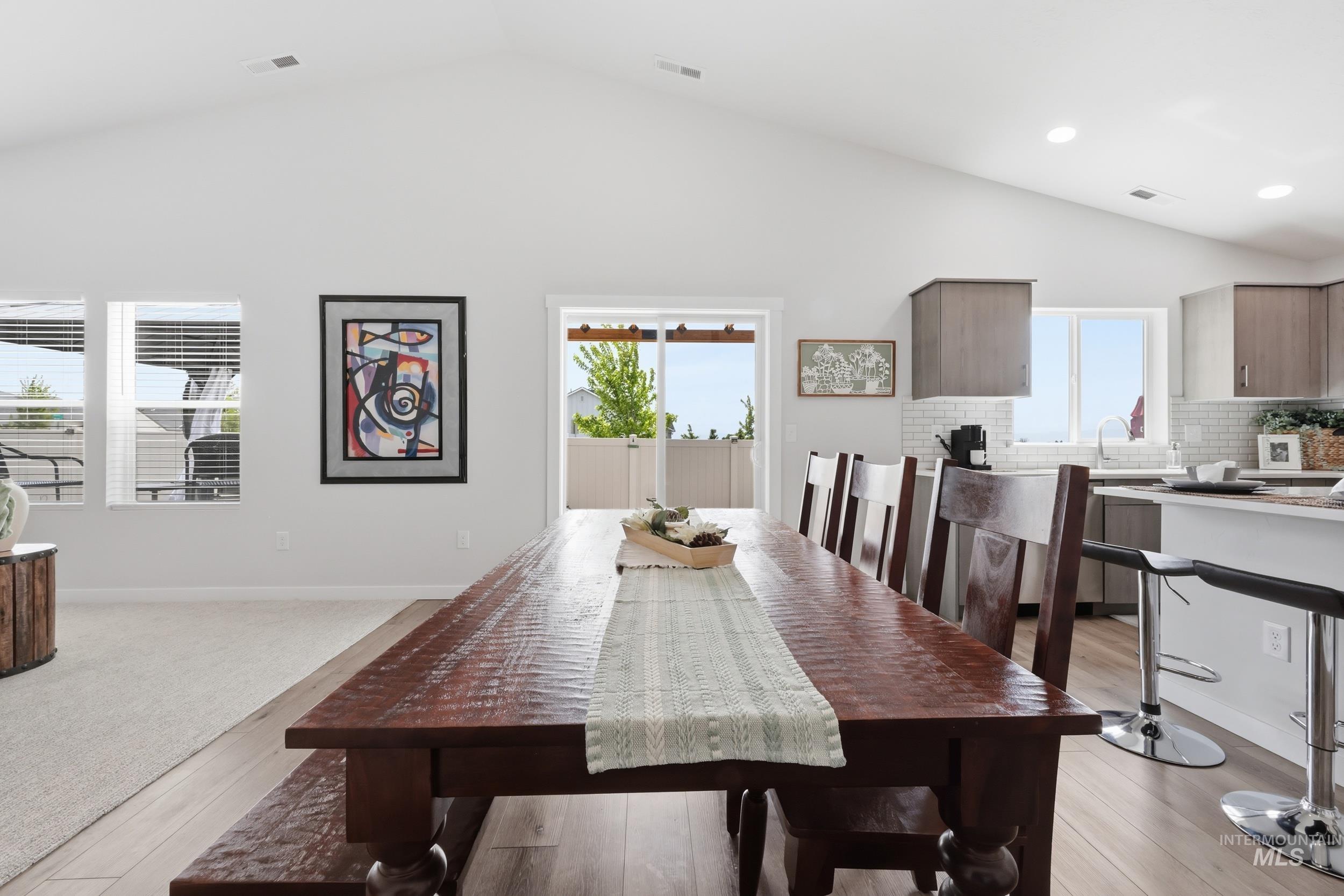 3665 W Lane Meridian, ID 83642 - Photo 12 of 42 Open-concept living space featuring vaulted ceilings, recessed lighting, and a contemporary ceiling fan