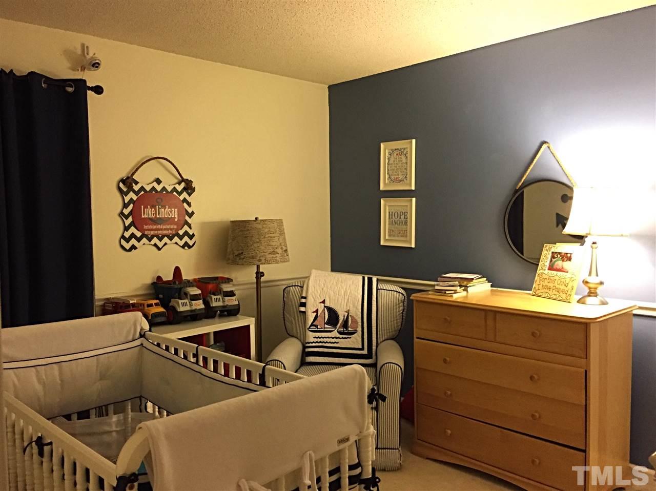 4114 Olde Coach Road Durham, NC 27707 - Photo 11 of 16 a bedroom with a bed and furniture