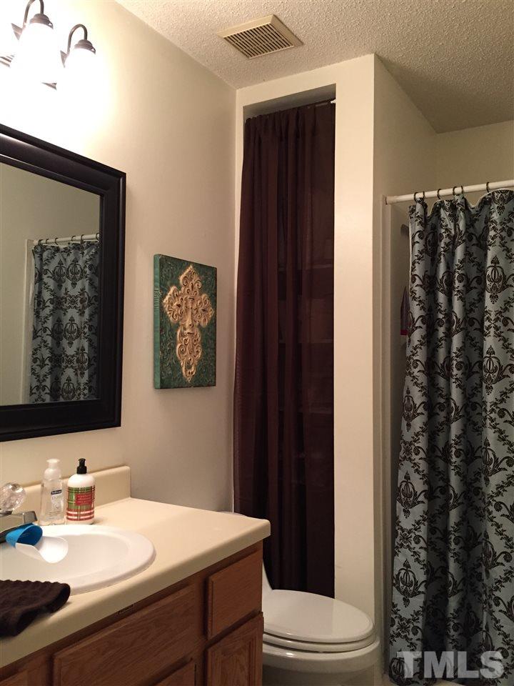 4114 Olde Coach Road Durham, NC 27707 - Photo 12 of 16 a bathroom with a sink and a mirror
