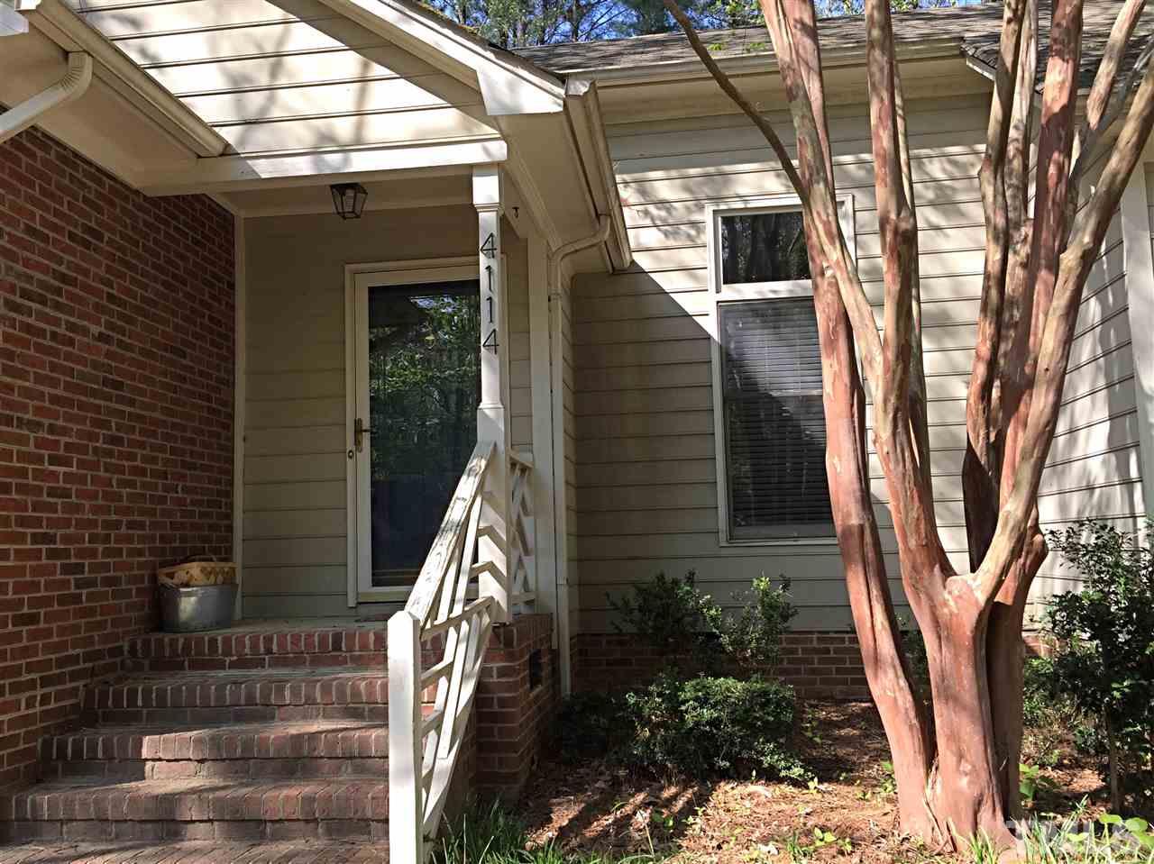 4114 Olde Coach Road Durham, NC 27707 - Photo 13 of 16 a view of house with backyard and trees