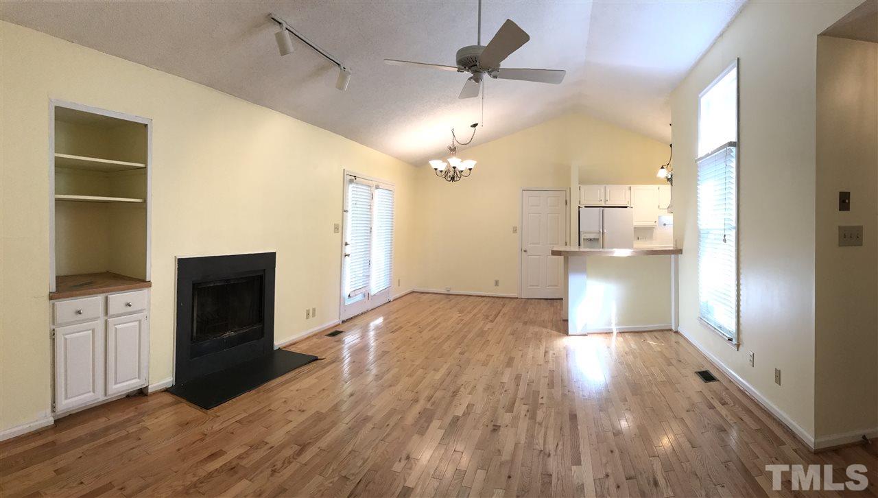 4114 Olde Coach Road Durham, NC 27707 - Photo 3 of 16 a living room with a fireplace and wooden floor
