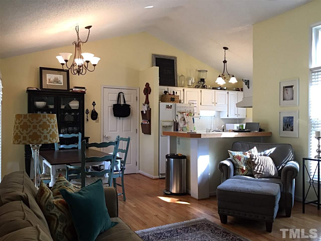 4114 Olde Coach Road Durham, NC 27707 - Photo 5 of 16 a living room with furniture and a chandelier