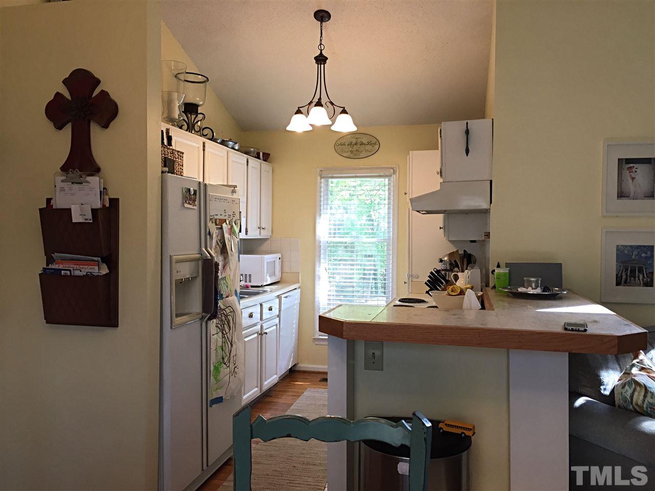 4114 Olde Coach Road Durham, NC 27707 - Photo 6 of 16 a kitchen with refrigerator and window