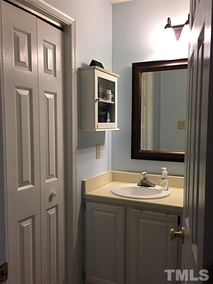 4114 Olde Coach Road Durham, NC 27707 - Photo 9 of 16 a bathroom with a sink and a mirror