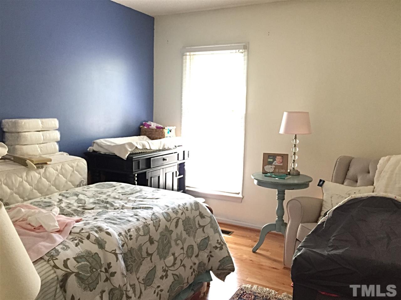 4114 Olde Coach Road Durham, NC 27707 - Photo 10 of 16 a bedroom with two beds and a lamp
