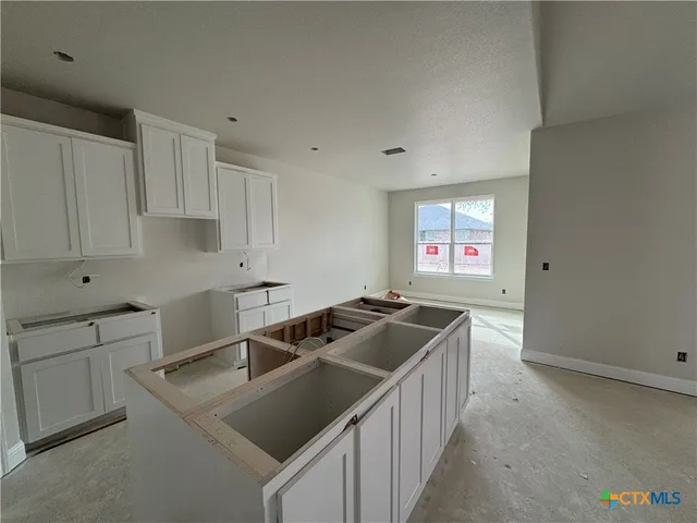 a kitchen that has a sink and a stove in it