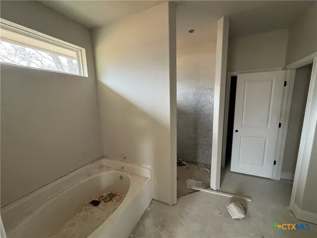 a view of storage and utility room with closet