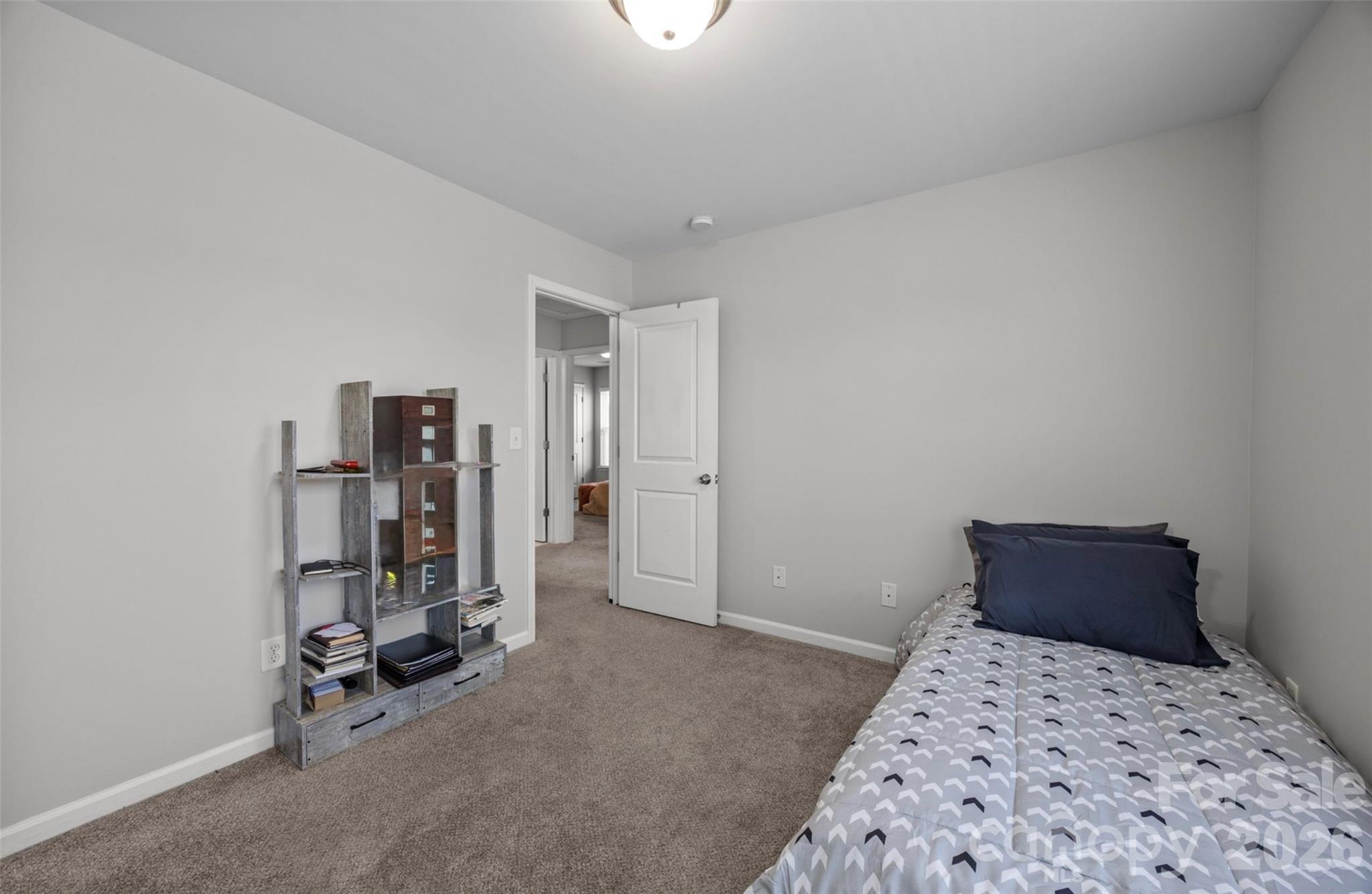 2707 Hunters Moon Lane Matthews, NC 28105 - Photo 13 of 27 a bedroom with a bed and a table in it