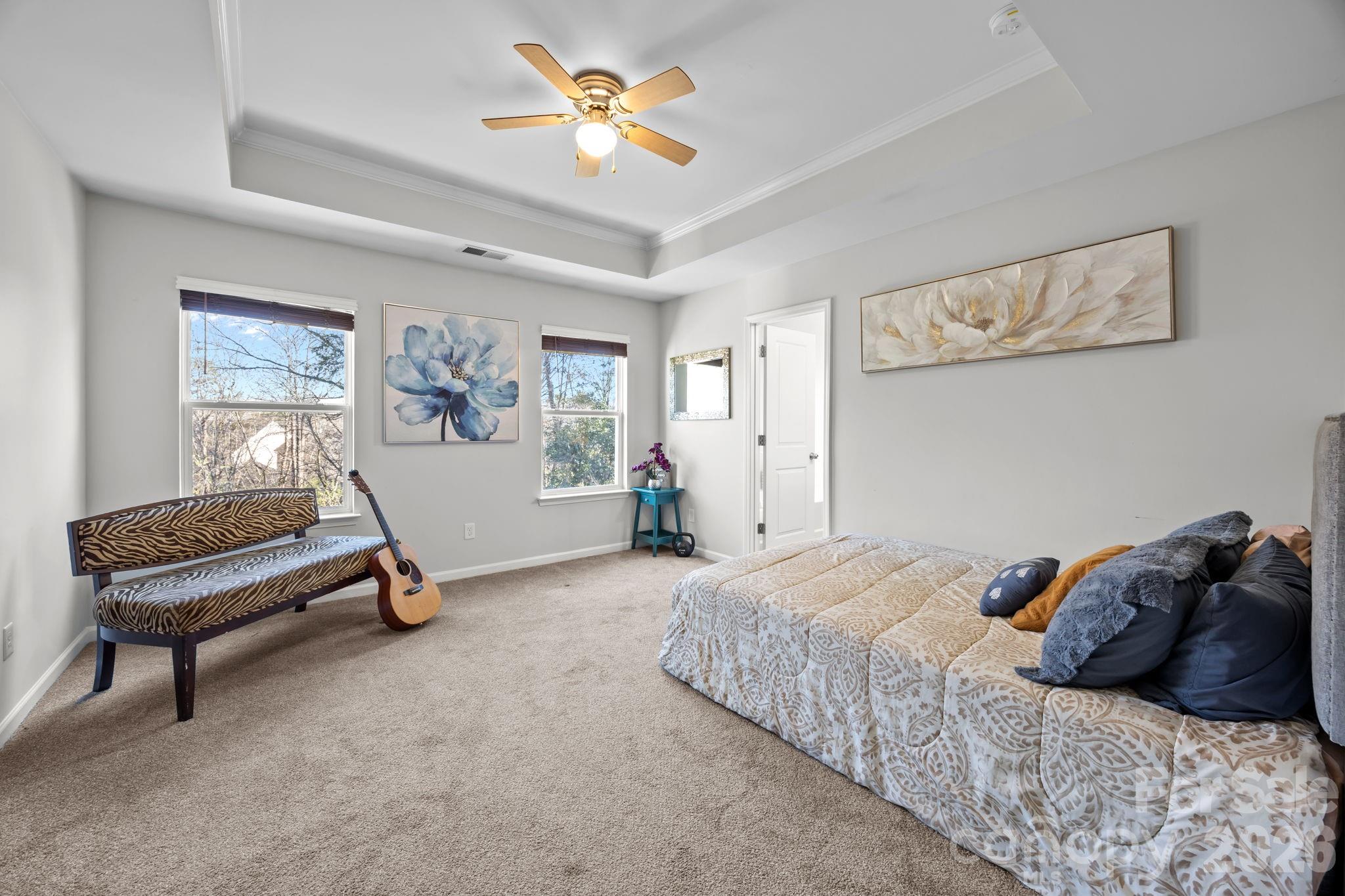 2707 Hunters Moon Lane Matthews, NC 28105 - Photo 16 of 27 a bedroom with a bed and a chandelier