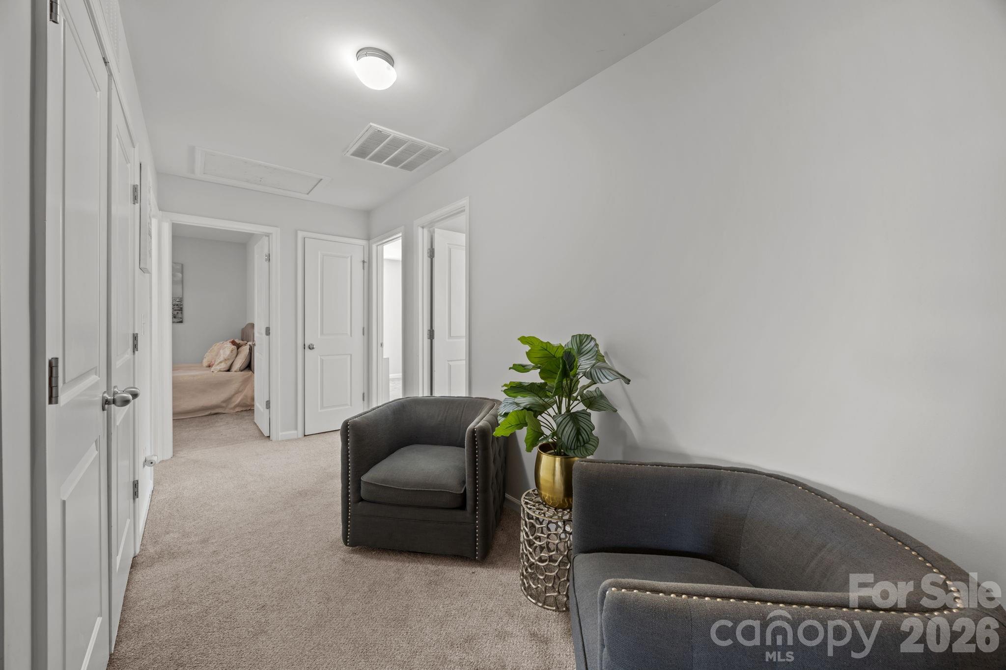 2707 Hunters Moon Lane Matthews, NC 28105 - Photo 22 of 27 a living room with furniture and a potted plant