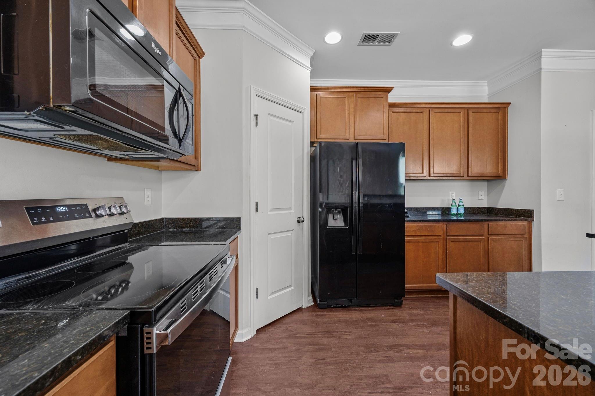 2707 Hunters Moon Lane Matthews, NC 28105 - Photo 6 of 27 a kitchen with stainless steel appliances granite countertop a refrigerator and a stove top oven