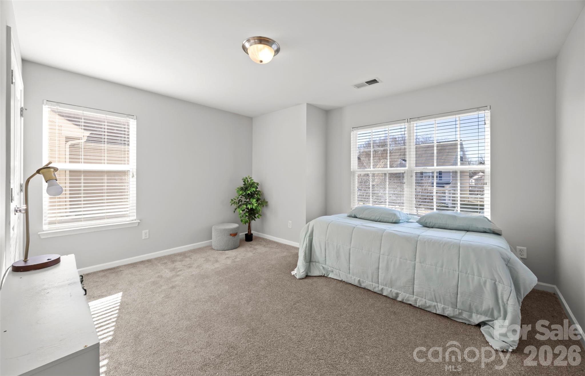 2707 Hunters Moon Lane Matthews, NC 28105 - Photo 9 of 27 a spacious bedroom with a bed and a window