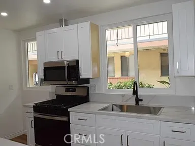a kitchen with a sink and a refrigerator