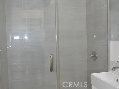 a bathroom with a shower and a sink