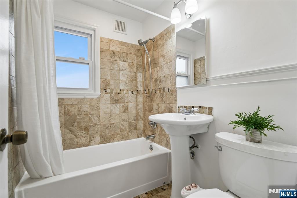 26 Rutgers Place Bloomfield, NJ 07003 - Photo 38 of 38 a bathroom with a sink a toilet and shower