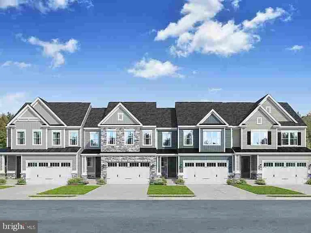 a front view of a house with dishwasher and garden