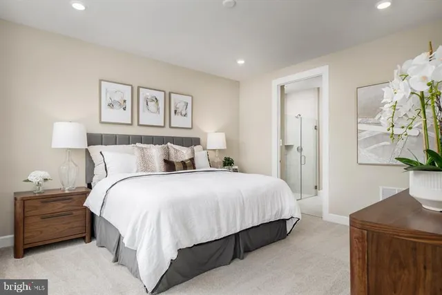 a bedroom with a bed and a painting on the wall